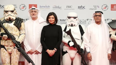 From left: Dubai International Film Festival artistic director Masoud Amralla Al Ali, managing director Shivani Pandya and chairman Abdulhamid Juma on the red carpet with Stormtroopers. Getty
