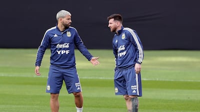 Sergio Aguero, left, and Lionel Messi talk during a practice session in Porto Alegre, Brazil. AP Photo