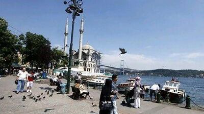 Tourists throng the Ottoman-era Ortakoy Mecidiye Mosque and Bosphorus Bridge in Istanbul. Turkey has become a hot destination for Arab tourists in recent years. Osman Orsal / Reuters