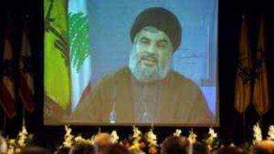 Hassan Nasrallah, the Hizbollah leader, announces the party's new political strategy through a video link in Beirut yesterday.
