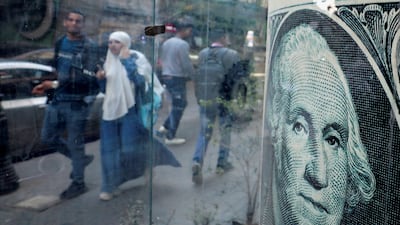 People walk past a currency exchange point in Cairo. Reuters