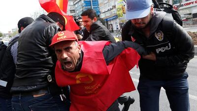 Plainclothes police officers detain a protester in Istanbul. Murad Sezer / Reuters