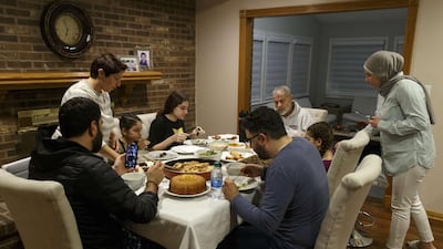 Abbas Al Haj Ahmed talks with his cousin Adam Bazzi over a video call while their family shares a meal and breaks fast on the first full day of Ramadan on April 24, 2020 in Dearborn. Getty Images via AFP