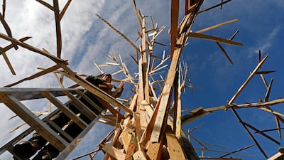 A craftsman adds parts to the sculpture 'Climate Tree' during the UN Climate Change Conference COP23 in Bonn, Germany. Ronald Wittek / EPA