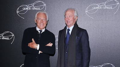 Leonardo Del Vecchio, right, the billionaire founder of Luxottica, attends a company event with Italian fashion designer Giorgio Armani. Getty