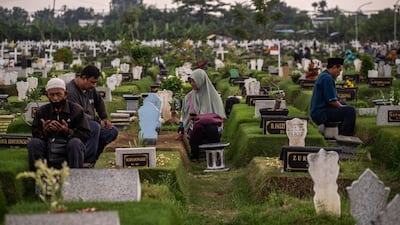 Families visit the graves of deceased relatives in Surabaya, Indonesia, as part of nyekar, a tradition that precedes Ramadan. AFP