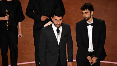 Israeli journalist and filmmaker Yuval Abraham (R) and Palestinian journalist and filmmaker Basel Adra accept the award for Best Documentary Feature for No Other Land at the Oscars. AFP