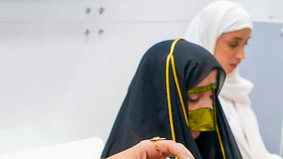 The women showcase various aspects of Emirati arts and crafts, from clothing to fragrance