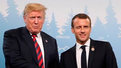 US President Donald Trump and French President Emmanuel Macron shake hands at a meeting on the sidelines of the G7 Summit in La Malbaie, Quebec, Canada. Ludovic Marin / AFP