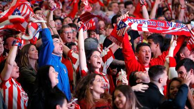 Supporters of Atletico Madrid celebrate the team's win in the UEFA Europa League final between Olympique Marseille and Atletico Madrid in Lyon, as they follow the match on giant screens at Atletico Madrid's Wanda Metropolitano Stadium in Madrid, Spain, on May 16, 2018. JuanJo Martin / EPA