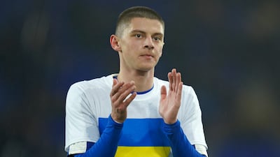 Everton's Vitaliy Mykolenko, from Ukraine, wearing the Ukrainian flag on his t-shirt, applauds before the FA Cup 5th round match between against Boreham Wood at Goodison Park. AP