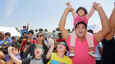 Youngsters scrambled up climbing ropes, negotiated bouncy castles and enjoyed pedal boat rides inside a small inflatable pool as part of the Reaching You Party in the Park event in Zabeel Park. Jaime Puebla / The National