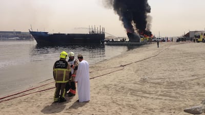 Fire crews in Dubai are trying to extinguish a fire that has spread to three boats moored on Dubai Creek. Antonie Robertson / The National