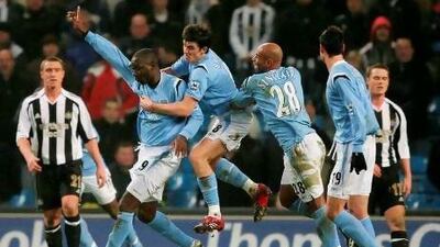 Andrew Cole believes Joey Barton, centre, his former Manchester City teammate, is too straightforward for his own good. Clive Mason / Getty Images