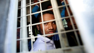 A Rohingya Muslim man looks out from inside a police vehicle, after he and others attended a court hearing on charges of illegally travelling without proper documents, in Pathein, Ayeyarwady, Myanmar December 20, 2019. Reuters
