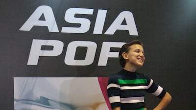 Millie Bobby Brown, wearing a striped green shirt and black jeans, attends Asia Pop Comic Con 2016 in Manila, Philippines, on August 28, 2016. Getty Images