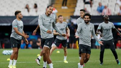 Van Dijk with Salah during training. Reuters