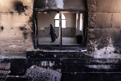A Palestinian man in a mosque allegedly burnt by Israeli settlers, in Qusra in the occupied West Bank. AFP
