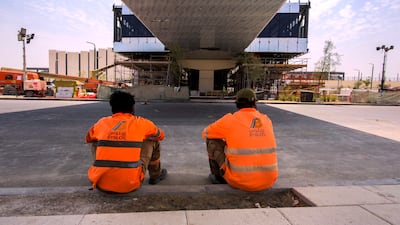 Two construction workers. Analysts believe the station will strengthen demand to live in the area and bolster transport links