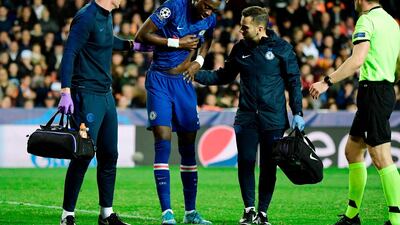 Chelsea striker Tammy Abraham is helped from the pitch after injuring his hip against Valencia in the Champions League. AFP
