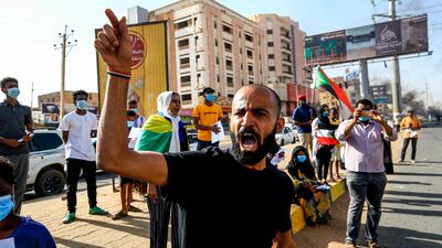 Sudanese protesters, some clad in masks as a precaution due to the coronavirus pandemic, chant slogans as they gather to mark the first anniversary of a raid on an anti-government sit-in, in the Riyadh district in the east of the capital Khartoum. AFP
