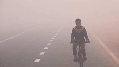 An Indian boy wearing a face mask cycles in smog, one day after the Diwali festival, in New Delhi, India, on October 31, 2016. According to a news report, hundreds of people faced breathing problem and poor visibility due to heavy smog after fireworks set off during the Diwali festival in Delhi have worsened the pollution problem. Rajat Gupta/EPA