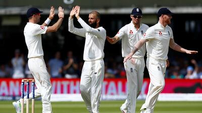 England's Moeen Ali (centre left) celebrates taking the wicket of South Africa's Dean Elgar Action (Reuters/Peter Cziborra)