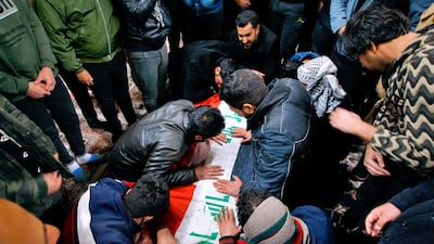 Mourners mourn by the flag-draped coffin of a suicide bomb victim, Samer Hassan, during his funeral procession at the Imam Ali shrine in Najaf, Iraq. AP