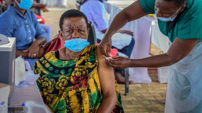 A woman receives a Covid-19 vaccination at the Kololo airstrip in Kampala, Uganda. AP Photo / Nicholas Bamulanzeki