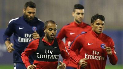 Paris Saint-Germain's (PSG) Italian goalkeeper Salvatore Sirigu (L, Back), Argentinian midfielder Javier Pastore (C, back), Brazilian winger Lucas Moura (C, front) and Brazilian defender Thiago Silva (R) take part in a training session at the team's training camp in the Qatari capital Doha, on December 29, 2015 on the eve of their friendly football match against Italian league leaders Inter Milan. AFP PHOTO / KARIM JAAFAR