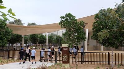 Children enjoy the animal barn at the new Mushrif Central Park. Delores Johnson / The National