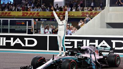 Race winner Lewis Hamilton celebrates on track. Getty Images