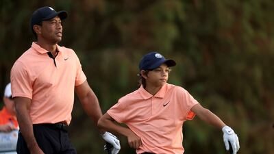 Tiger Woods and Charlie wait to play on the 17th hole. AFP