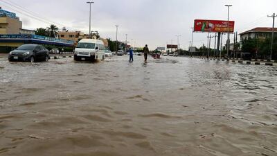 Cars drive along a flooded street in Khartoum after torrential rain fell on the Sudanese capital, almost paralising traffic, on August 8, 2021. (Photo by ASHRAF SHAZLY / AFP) (Photo by ASHRAF SHAZLY / AFP via Getty Images)
