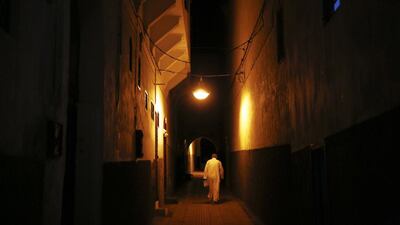 A man leaves a mosque after evening prayers in Medina, Rabat’s old city.