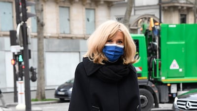 Brigitte, wearing a black cape over trousers, attends a tribute for French designer Pierre Cardin in Paris, on January 29, 2021. AFP