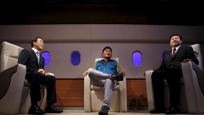 A man sits between the wax figures of UN Secretary-General Ban Ki-moon, left, and Chinese president Xi Jinping, right, at Grevin Wax Museum in Seoul, South KoreKim Hong-Ji / Retuers