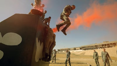 The students jump off an obstacle.