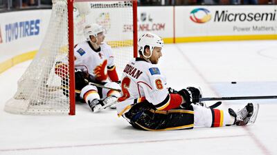 Dennis Wideman and Joe Colborne of the Calgary Flames react to an empty net goal by Ryan Kesler #17 of the Anaheim Ducks. Sean M Haffey / Getty Images / AFP