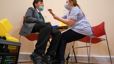 Felix Dima, 13, receives his flu inoculation ahead of receiving a Covid-19 vaccine at the Excelsior Academy in Newcastle upon Tyne. Getty Images