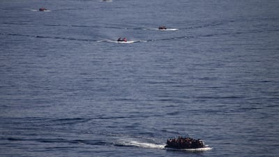 Refugees and migrants are seen onboard eight dinghies as they cross a part of the Aegean Sea from the Turkish coast to reach the Greek island of Lesbos, October 4, 2015. REUTERS/Dimitris Michalakis/File Photo