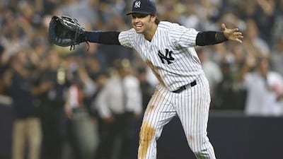 Nick Swisher celebrates the New York Yankees winning the AL East title, his former team the Oakland Athletics won the AL West.