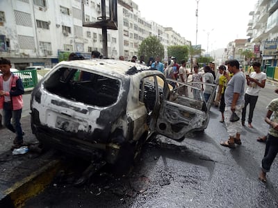 A crowd gathers around a car that exploded in the Madram street in the Al Mualla area in Aden on Tuesday. Photo by Ali Mahmood
