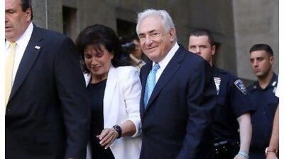 Dominique Strauss-Kahn, centre, leaves court in New York after his hearing in the sexual assault case against him on Friday.