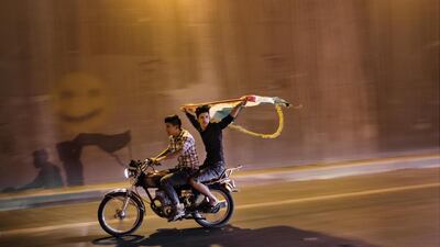 ERBIL, IRAQ: Young men drive through the streets on the eve of the Kurdish independence referendum.
