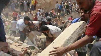 People search for survivors under the rubble of homes after a massive rock slide off Moqattam hill in northern Cairo on Sept. 6.