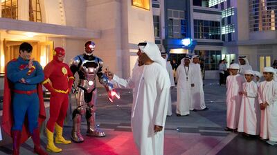 Sheikh Saif takes a photo of the superheroes at the opening of Warner Bros World Abu Dhabi. Eissa Al Hammadi for The Crown Prince Court