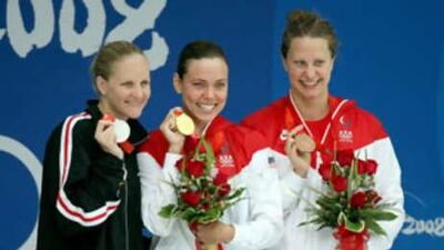 The silver medalist Kirsty Coventry of Zimbabwe, the gold medalist Natalie Coughlin of the United States and the bronze medalist Margaret Hoelzer.