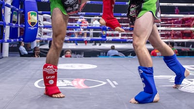 Bilal Ibrahim of UAE, red, against Riley Foden of Canada at ADNEC in Abu Dhabi.