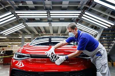 A worker assembles Volkswagen ID.5 electric cars at the company's Zwickau plant in Germany. Volkswagen is pumping $39 billion into the shift to EVs and aims to become the world's largest electric carmaker by 2025. Getty
